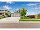 Two-story home with three-car garage, manicured lawn, and professional landscaping at 10 N Quantock St, Aurora, CO 80018