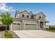 Attractive home with a three-car garage, enhanced by a beautifully designed front yard and mature trees at 10 N Quantock St, Aurora, CO 80018