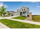 Charming two-story home with a cozy front porch, three-car garage, and beautifully landscaped yard at 10 N Quantock St, Aurora, CO 80018