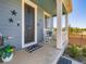 Cozy front porch with rocking chairs, decorative stars, and a welcoming 'hello' doormat, creating a charming entrance at 10 N Quantock St, Aurora, CO 80018