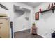 Hallway with wood-look floors, leading to stairs and displaying art on the walls at 10 N Quantock St, Aurora, CO 80018