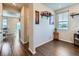 Hallway with wood flooring leading to a home office with a window and wall decor at 10 N Quantock St, Aurora, CO 80018