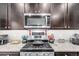 Modern kitchen with stainless steel appliances and granite countertops at 10 N Quantock St, Aurora, CO 80018