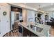 Bright kitchen featuring a large island, stainless steel appliances, and seamless flow to the living area at 10 N Quantock St, Aurora, CO 80018