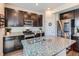 Contemporary kitchen showcasing granite countertops, stainless steel appliances, and dark wood cabinetry at 10 N Quantock St, Aurora, CO 80018