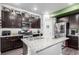 Modern kitchen with granite countertops, stainless steel appliances, and a stylish center island at 10 N Quantock St, Aurora, CO 80018