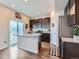 Modern kitchen features an island with granite countertops, stainless steel appliances, and dark wood cabinetry at 10 N Quantock St, Aurora, CO 80018