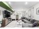 Spacious living room with comfortable seating, stylish decor, and a large television at 10 N Quantock St, Aurora, CO 80018