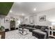 Comfortable living room with sectional sofa, contemporary decor, and ample lighting at 10 N Quantock St, Aurora, CO 80018