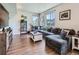 Comfortable living room boasts natural light, a sectional couch, and stylish décor, creating an inviting atmosphere at 10 N Quantock St, Aurora, CO 80018