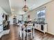 Open-concept living space with dining area featuring hardwood floors, modern lighting, and seamless flow at 10 N Quantock St, Aurora, CO 80018