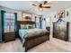Main bedroom featuring wooden furniture, a ceiling fan, and a view of the ensuite bathroom at 10 N Quantock St, Aurora, CO 80018