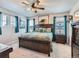 Spacious primary bedroom with a large bed, stylish furnishings, and ample natural light from the windows at 10 N Quantock St, Aurora, CO 80018
