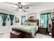 Comfortable bedroom boasts a ceiling fan, king bed, and natural light at 10 N Quantock St, Aurora, CO 80018