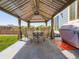Backyard patio area, including a table and six chairs under a gazebo at 10 N Quantock St, Aurora, CO 80018