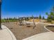 Community playground with swings, climbing structures, and soft ground cover for safety at 10 N Quantock St, Aurora, CO 80018