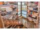 Modern staircase with wood steps, metal railings, and artistic wall decor, showcasing style and sophistication at 10 N Quantock St, Aurora, CO 80018