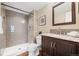Updated bathroom features a tiled shower, modern vanity, and neutral color palette at 3400 S Eagle St # 104, Aurora, CO 80014