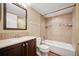 Bathroom featuring a bathtub, tiled shower, and vanity with solid surface countertops at 3400 S Eagle St # 104, Aurora, CO 80014
