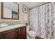 Stylish bathroom with wood-look floors, modern vanity, and marble-patterned shower curtain at 3400 S Eagle St # 104, Aurora, CO 80014