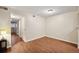 This bedroom features neutral walls, wood floors, closet, and a bright open window at 3400 S Eagle St # 104, Aurora, CO 80014