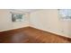 Cozy bedroom with wood floors and two windows providing natural light at 3400 S Eagle St # 104, Aurora, CO 80014