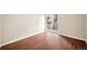 Bright bedroom featuring wood floors and a sliding glass door to a private balcony at 3400 S Eagle St # 104, Aurora, CO 80014