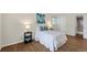 Comfortable bedroom featuring wood-look tile floors and a bright ensuite bathroom at 3400 S Eagle St # 104, Aurora, CO 80014