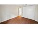 Bedroom featuring wood floors and closet with sliding doors at 3400 S Eagle St # 104, Aurora, CO 80014