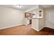 The dining room features wood floors and an open view into the kitchen at 3400 S Eagle St # 104, Aurora, CO 80014