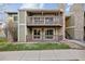Attractive two-story condo features dual patios and a stylish stone chimney against a blue sky at 3400 S Eagle St # 104, Aurora, CO 80014