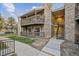 This exterior view shows two-story condos with wooden decks and stone detailing at 3400 S Eagle St # 104, Aurora, CO 80014