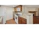 This kitchen features wood cabinets, granite countertops, and a view into the living room at 3400 S Eagle St # 104, Aurora, CO 80014