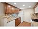 This kitchen features granite countertops, wood cabinets, stainless steel sink, and decorative backsplash at 3400 S Eagle St # 104, Aurora, CO 80014