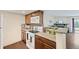 Bright kitchen featuring granite countertops, tile backsplash, and wood-look flooring at 3400 S Eagle St # 104, Aurora, CO 80014