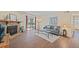 A welcoming living room features wood floors, stone fireplace, and sliding door to a private patio at 3400 S Eagle St # 104, Aurora, CO 80014