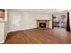 This living room features wood floors, a fireplace, and a sliding glass door to the outside at 3400 S Eagle St # 104, Aurora, CO 80014