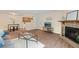 Charming living room with wood-look floors, stone fireplace, and open layout at 3400 S Eagle St # 104, Aurora, CO 80014