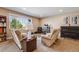 Finished basement area with carpet, recliners, a piano and a bookcase with a view at 13912 Ashgrove Cir, Parker, CO 80134