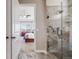 Elegant bathroom featuring a glass shower and a view of the primary bedroom with bay windows at 13912 Ashgrove Cir, Parker, CO 80134