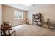Carpeted bedroom with a bookcase, chairs, a window, and decorative furniture at 13912 Ashgrove Cir, Parker, CO 80134