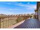 A wooden deck overlooks neighborhood homes under a bright, blue, partly cloudy sky at 13912 Ashgrove Cir, Parker, CO 80134