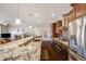 Open-concept kitchen with a large island, stainless steel appliances, and view into the living room at 13912 Ashgrove Cir, Parker, CO 80134
