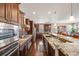 Gourmet kitchen featuring granite countertops, stainless steel appliances, and dark wood cabinets at 13912 Ashgrove Cir, Parker, CO 80134
