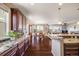 Spacious kitchen with granite countertops and dark wood cabinets, open to the dining and living area at 13912 Ashgrove Cir, Parker, CO 80134