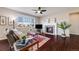 Comfortable living room featuring a fireplace and hardwood floors with large windows providing natural light at 13912 Ashgrove Cir, Parker, CO 80134