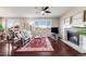 Inviting living room features a fireplace, large windows, and flows into dining area at 13912 Ashgrove Cir, Parker, CO 80134
