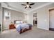 Spacious primary bedroom features a ceiling fan, carpet flooring, and an ensuite bathroom at 13912 Ashgrove Cir, Parker, CO 80134