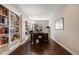 Well-lit home office featuring built-in bookshelves and hardwood floors for a productive workspace at 13912 Ashgrove Cir, Parker, CO 80134