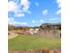 A community playground with climbing features, benches, and sidewalks surrounded by green grass at 13912 Ashgrove Cir, Parker, CO 80134